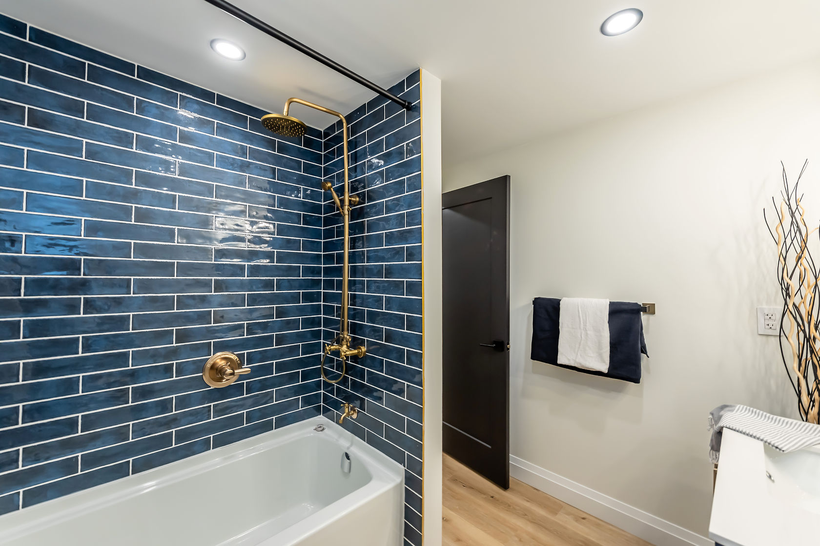 Stunning finished bathroom with dramatic navy subway tile and brass fixtures — premium portfolio shot with strong design impact — Gateshead, Hamilton | MTC Renovations